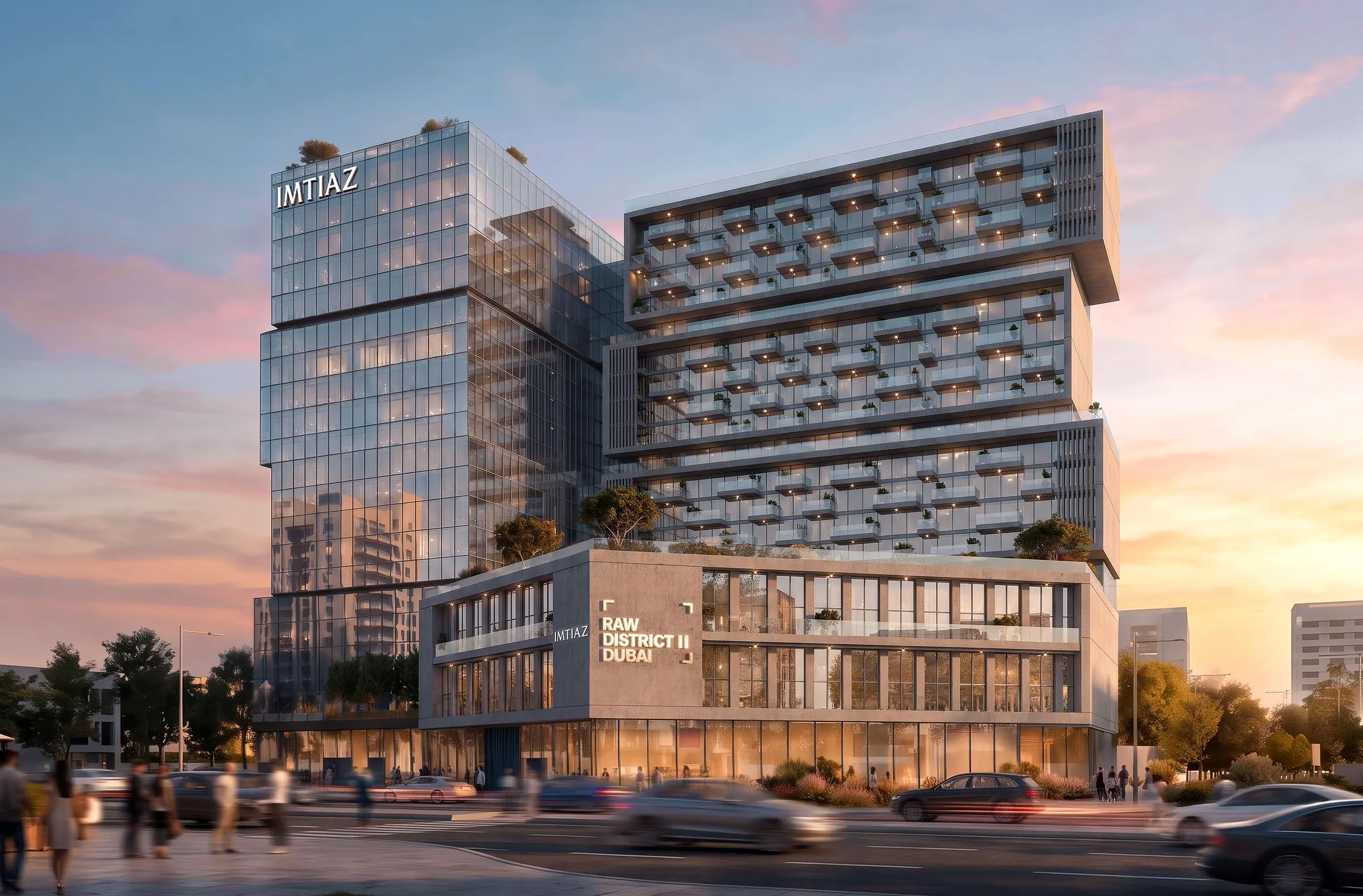 Raw District II at sunset: a glass office tower beside stacked residential blocks with planted terraces, on Sheikh Zayed Road