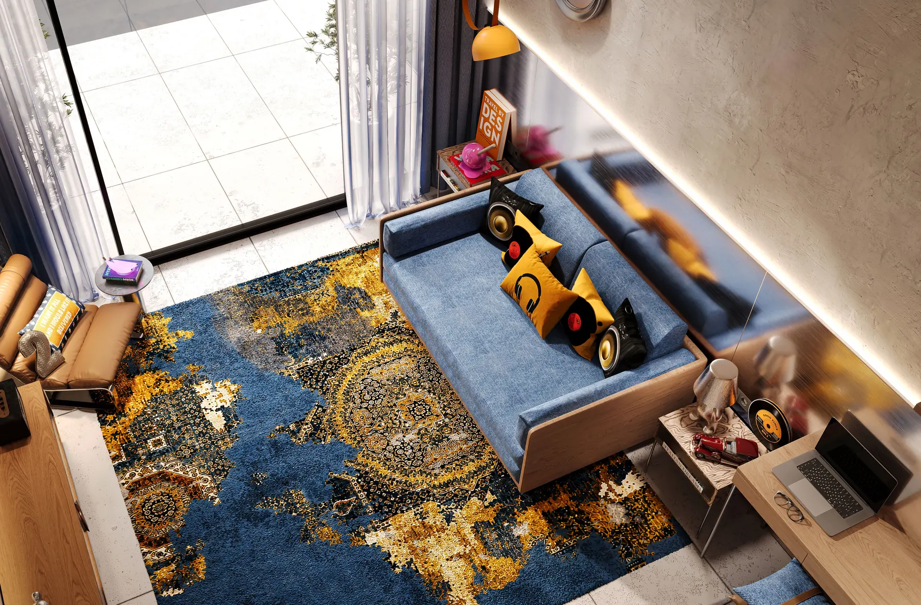 Studio apartment from above: a blue sofa on a gold and navy rug beside a full-height window